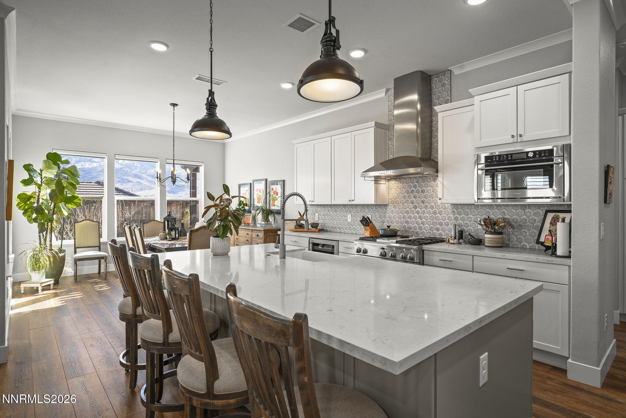 8726 Larkhaven Court Reno, NV 89523 - Photo 9 of 41 a kitchen with stainless steel appliances granite countertop a stove a refrigerator a sink a stove and white cabinets with wooden floor