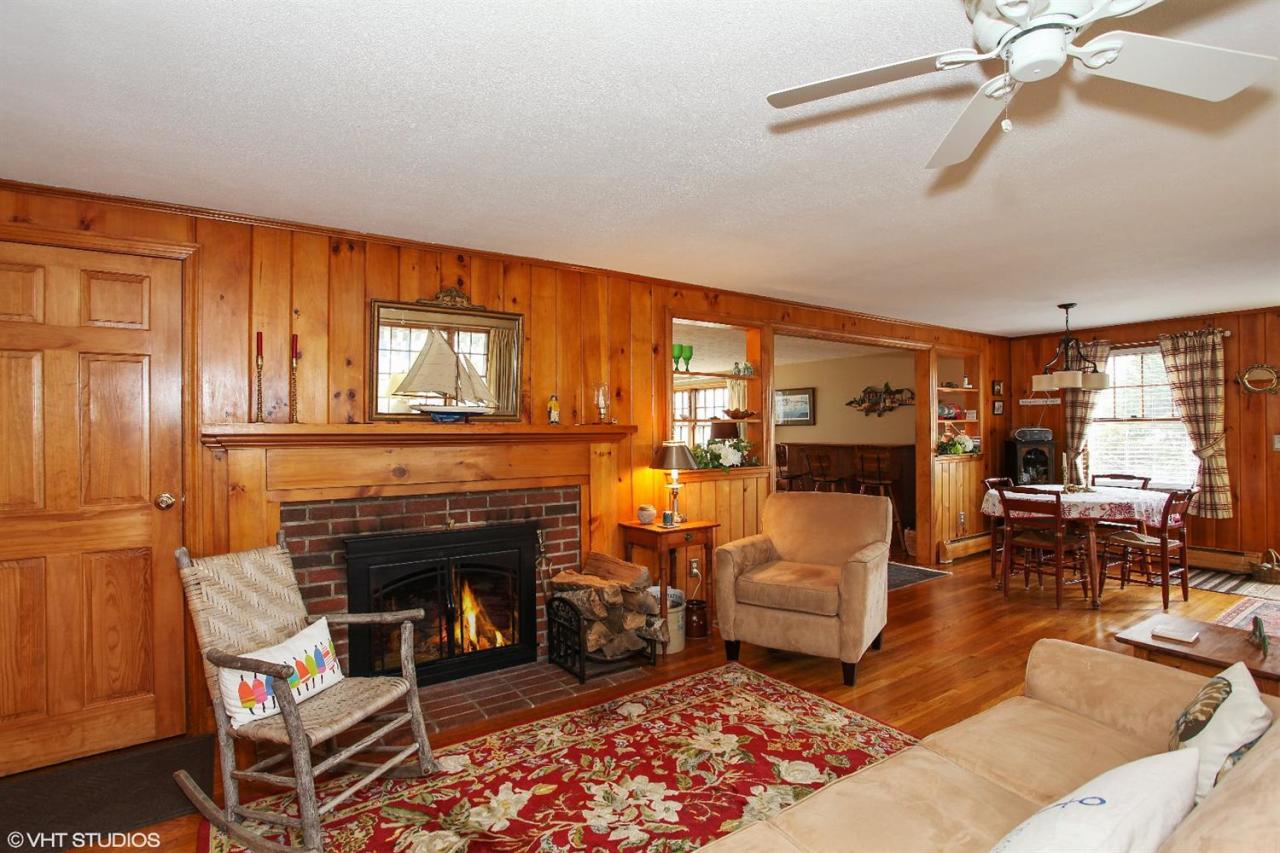 58 Rope Walk Road Bourne, MA 02532 - Photo 3 of 20 a living room with furniture a fireplace and a table