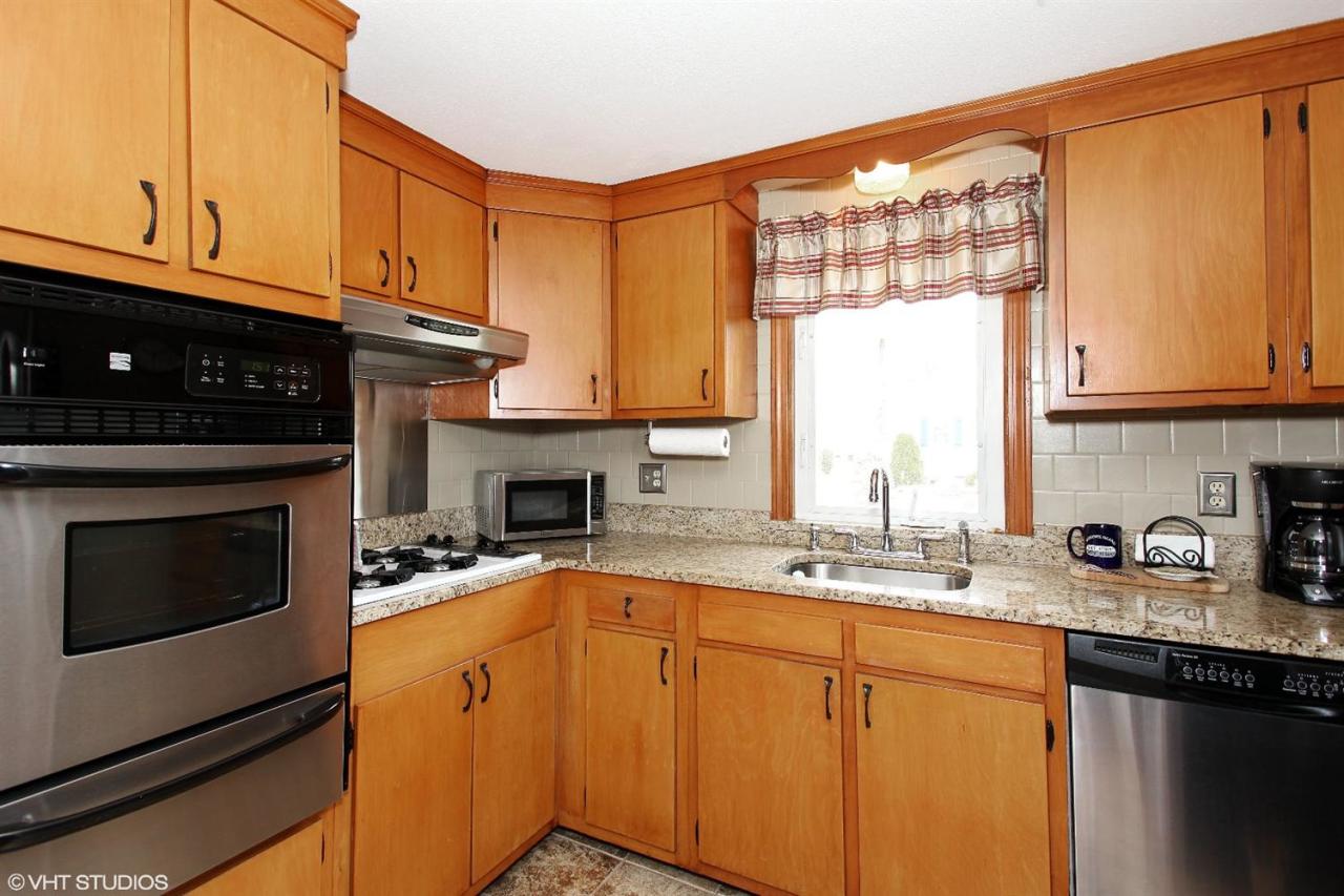 58 Rope Walk Road Bourne, MA 02532 - Photo 6 of 20 a kitchen with granite countertop a sink a stove and cabinets