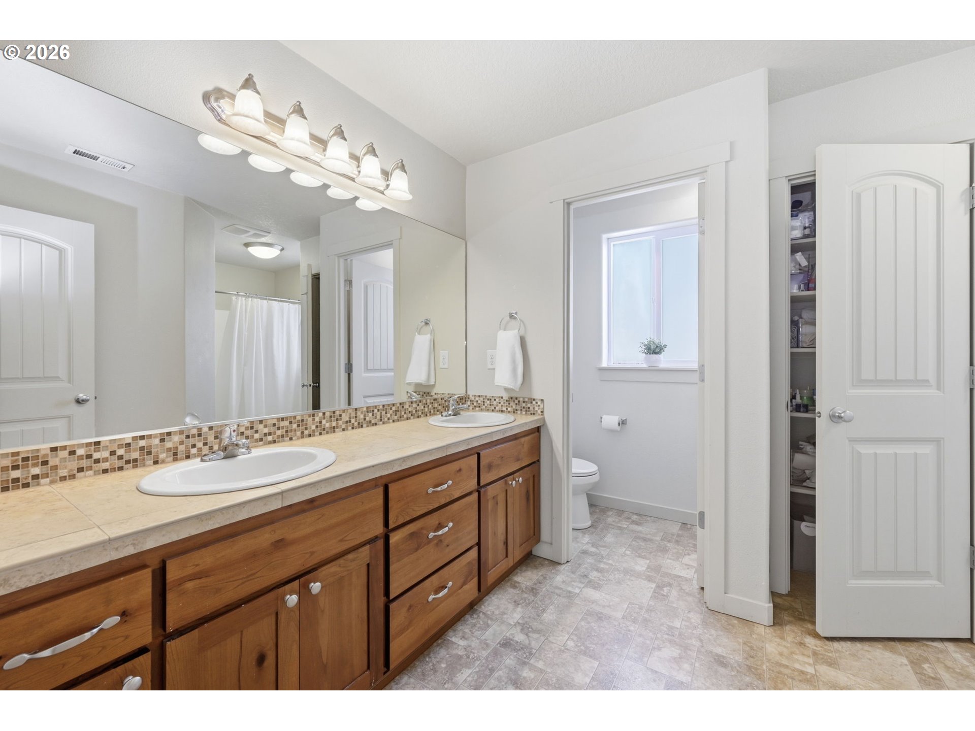 5442 Pranz Place Eugene, OR 97402 - Photo 15 of 34 a bathroom with a granite countertop sink a large mirror and a shower