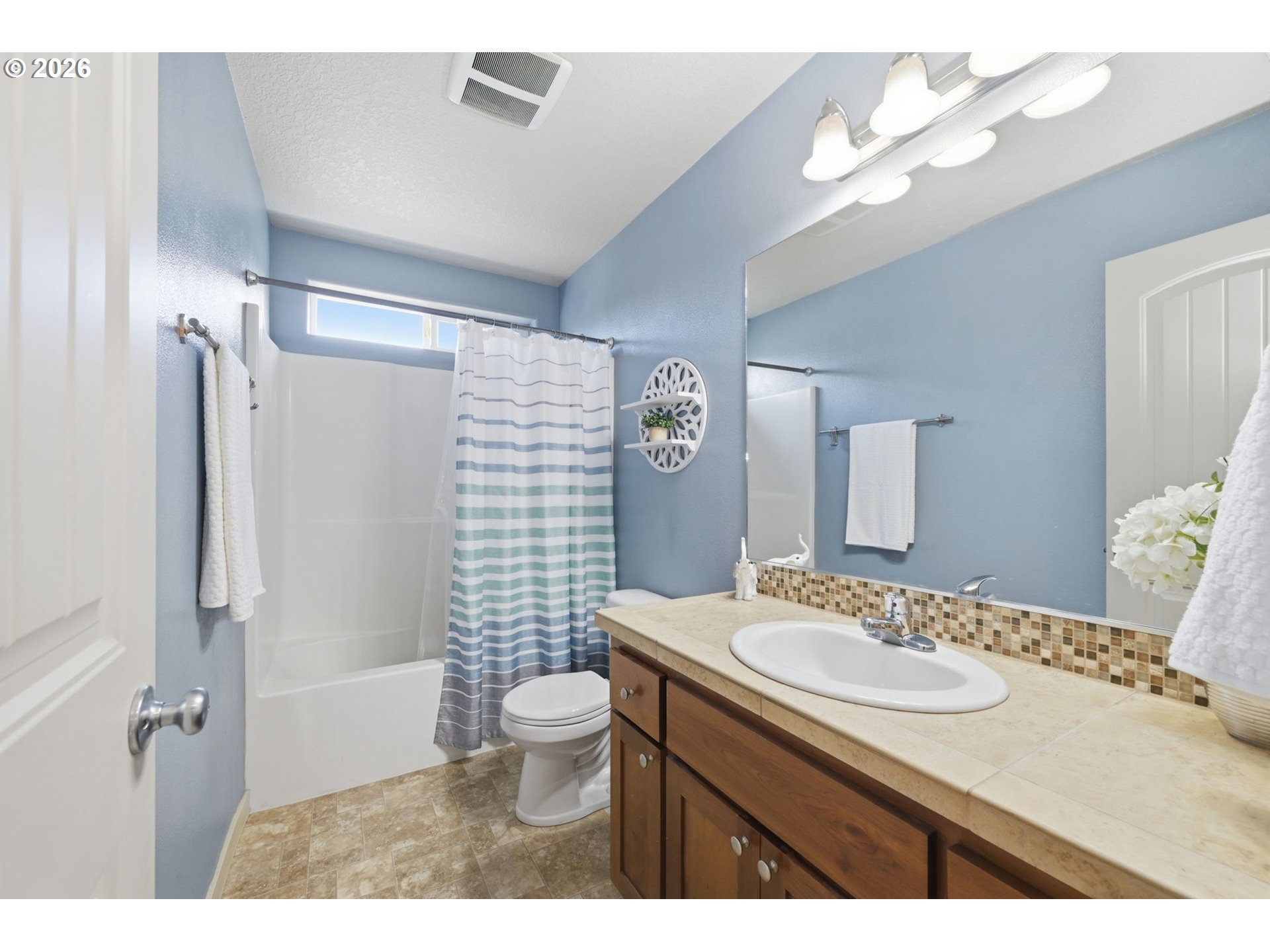 5442 Pranz Place Eugene, OR 97402 - Photo 19 of 34 a bathroom with a sink a toilet a mirror a vanity and shower