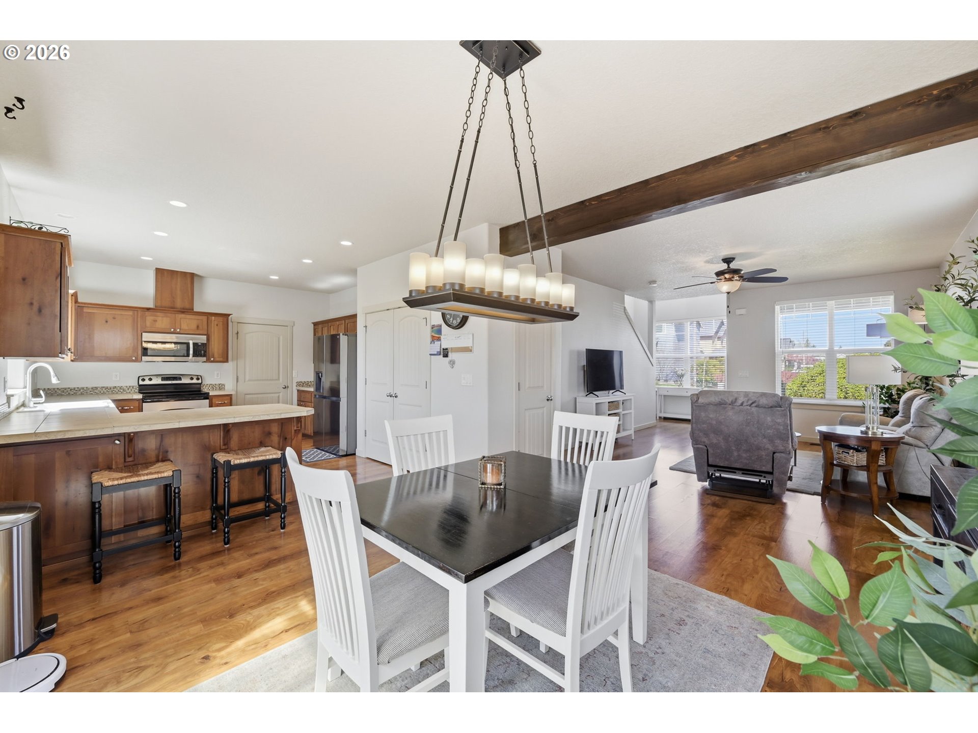 5442 Pranz Place Eugene, OR 97402 - Photo 10 of 34 a kitchen with stainless steel appliances kitchen island granite countertop a table chairs and a living room view