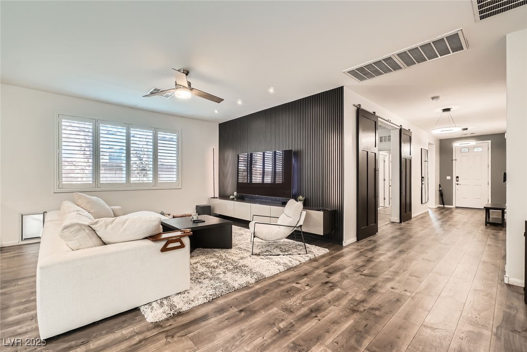 6233 Canterbury Field Road Las Vegas, NV 89113 - Photo 5 of 25 Living room with ceiling fan, wood finished floors, and recessed lighting