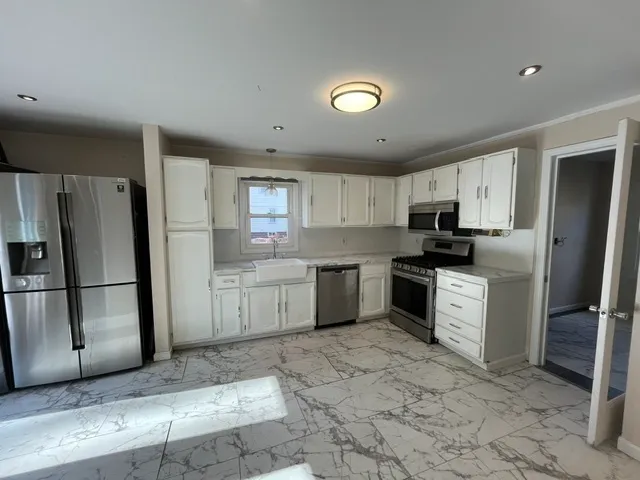 a kitchen with a refrigerator sink and microwave