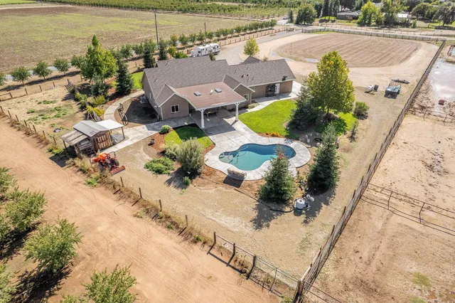 a living room with furniture and a flat screen tv with kitchen view