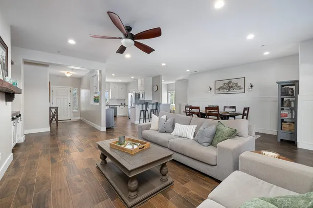 a living room with furniture and wooden floor
