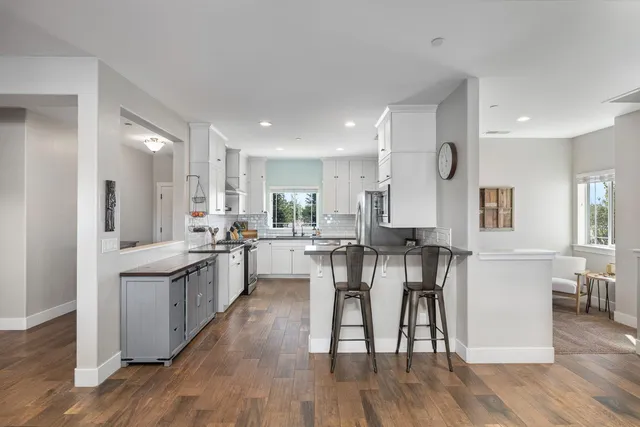 a kitchen with stainless steel appliances a refrigerator stove microwave and cabinets