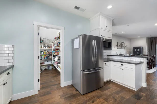 a spacious bedroom with a bed and a chandelier
