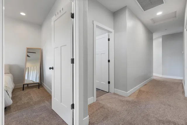 a bedroom with a bed a chandelier and a window