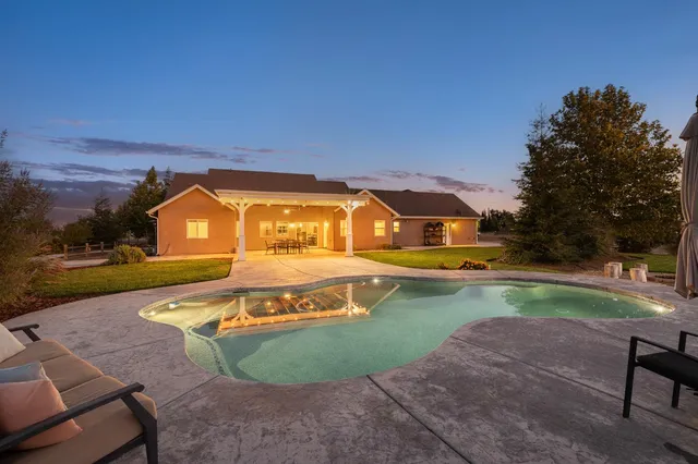 a view of a house with entertaining space and a view of the trees
