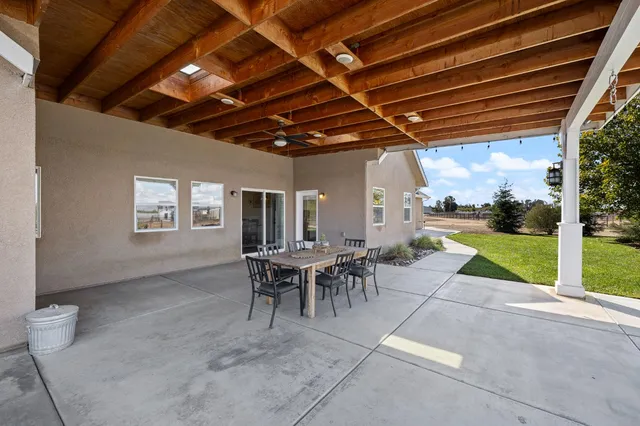 an aerial view of a house with a yard and lake view