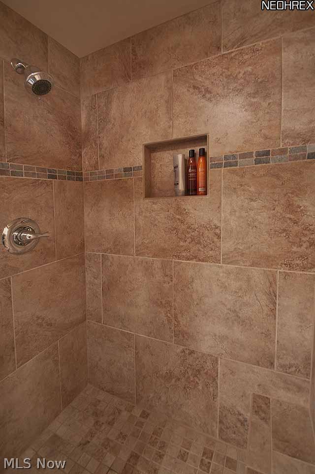 357 Longspur Road Highland Heights, OH 44143 - Photo 14 of 22 Gorgeous master glamour bath features 12 ft. high cathedral ceiling, granite countertop, cherry cabinets with tons of drawers, under-mount Kohler porcelain sink, built in sit-down make-up area, large jetted tub, mosaic tile backsplash and trim, and 18â?� porcelain tile on floors and to ceiling in fabulous large shower with oversized rain-style shower head