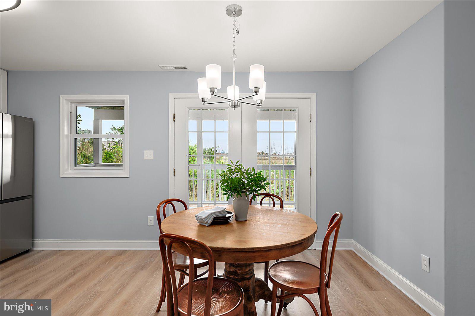 135 Jamestown Road, Unit 18A Ocean City, MD 21842 - Photo 25 of 63 a view of a dining room with furniture and wooden floor