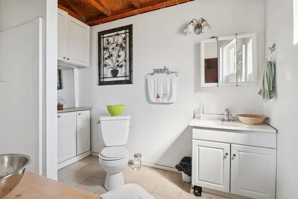 a bathroom with a toilet sink and mirror