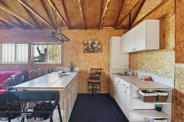 a kitchen with a sink stove and cabinets