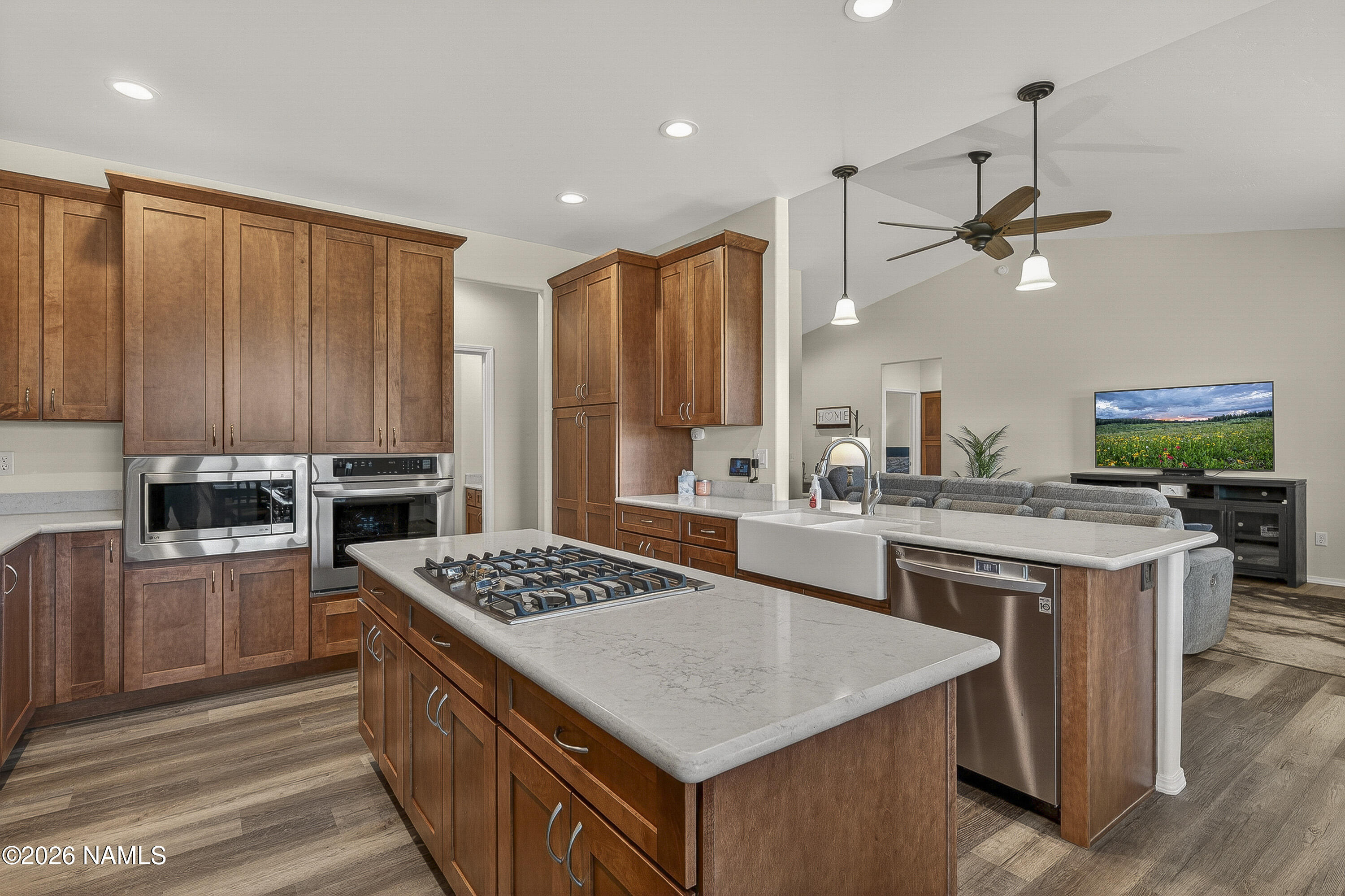6560 Johnson Ranch Road Flagstaff, AZ 86004 - Photo 12 of 57 a kitchen with stainless steel appliances granite countertop a stove a sink dishwasher and a refrigerator with wooden floor