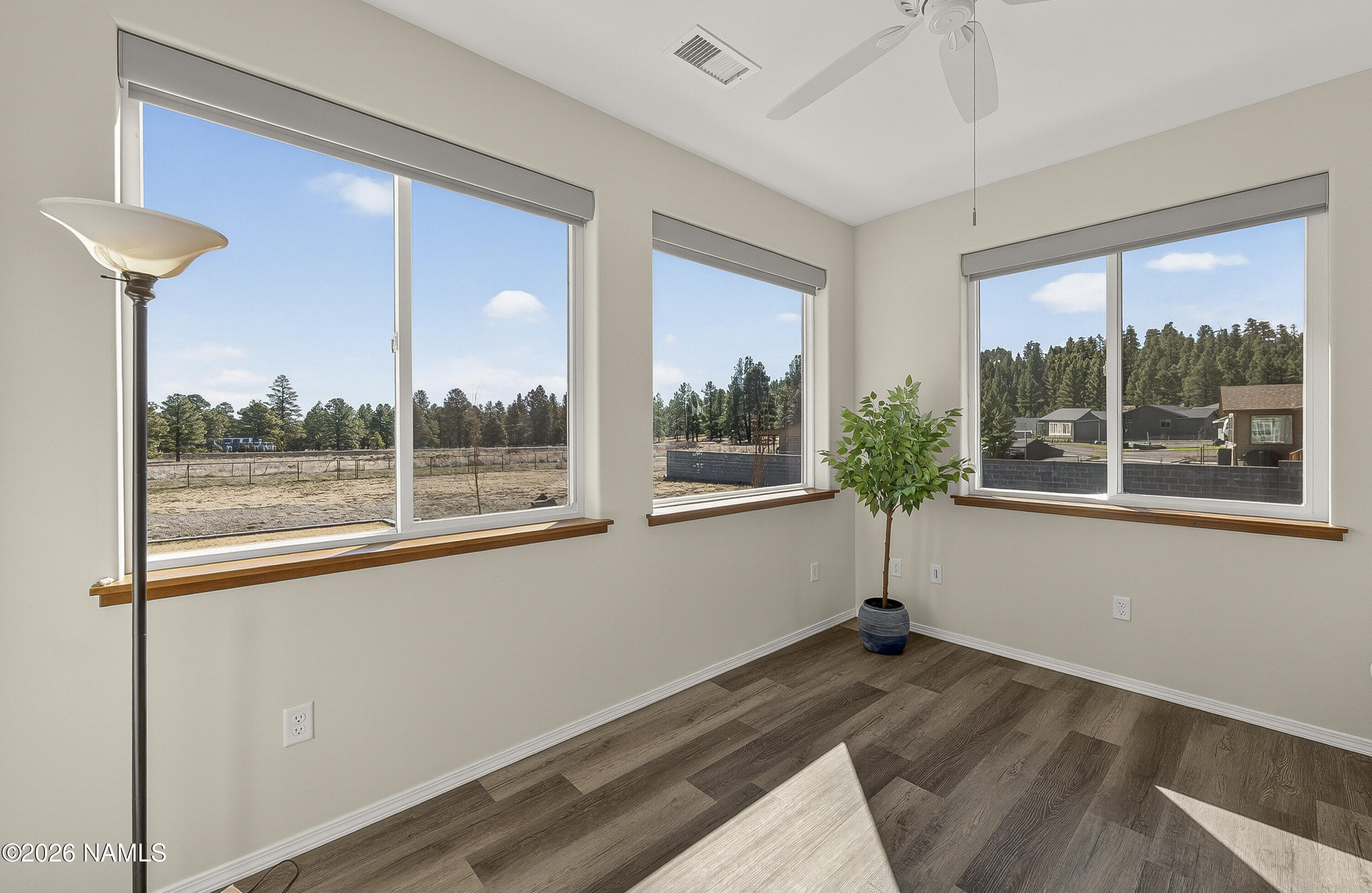 6560 Johnson Ranch Road Flagstaff, AZ 86004 - Photo 16 of 57 a view of empty room with wooden floor and fan