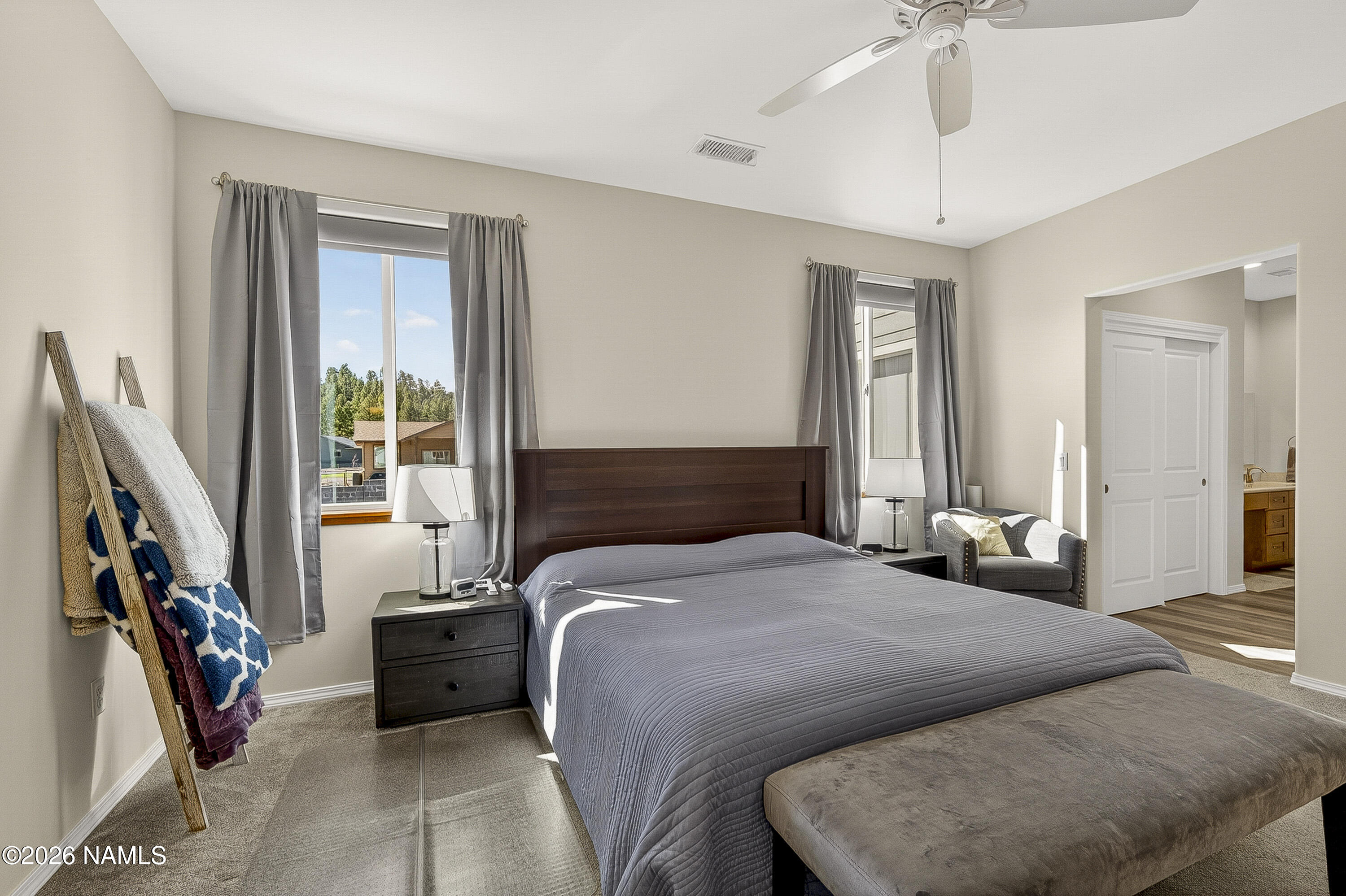 6560 Johnson Ranch Road Flagstaff, AZ 86004 - Photo 20 of 57 a bedroom with a large bed and a window
