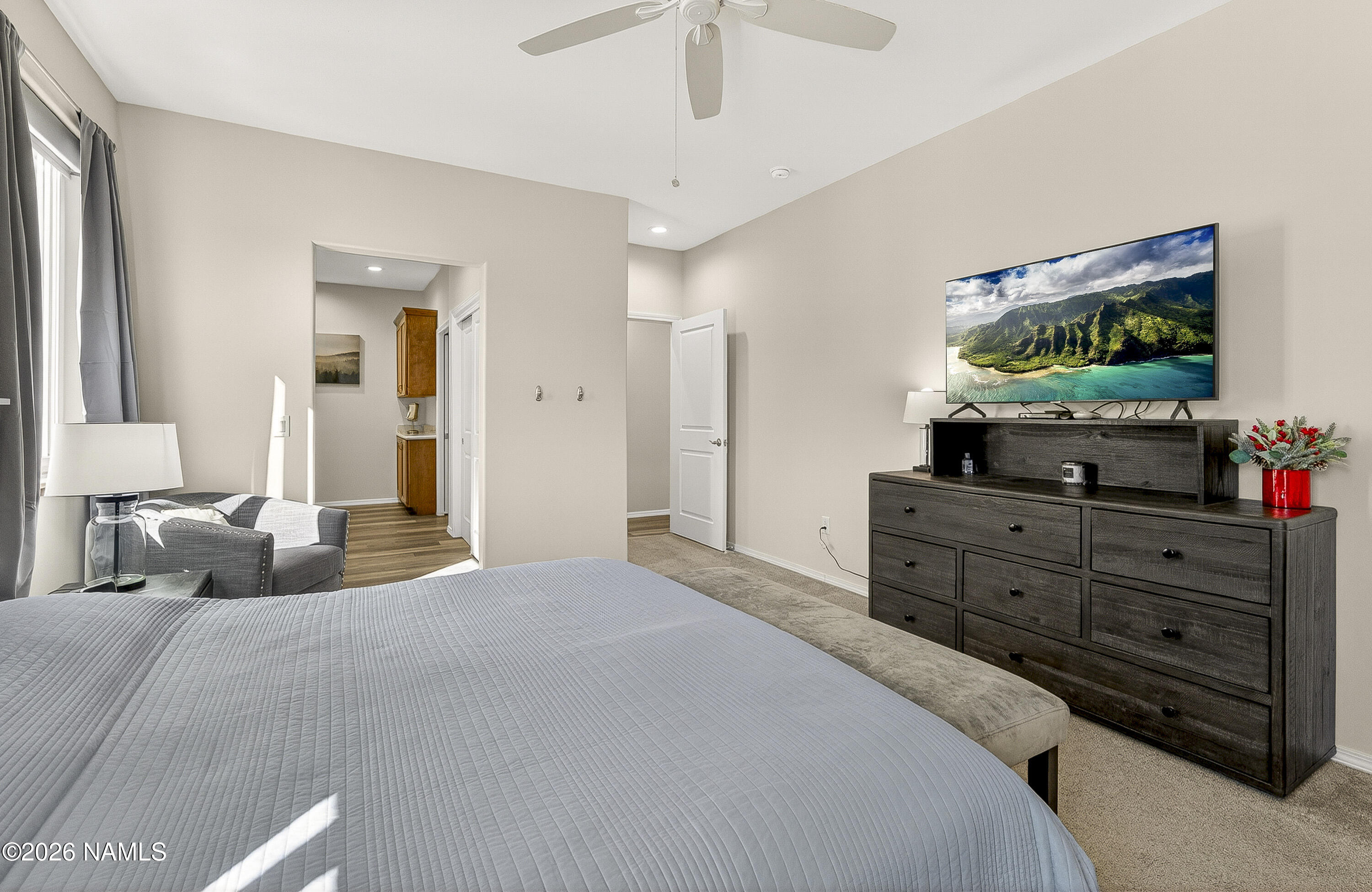 6560 Johnson Ranch Road Flagstaff, AZ 86004 - Photo 21 of 57 a bedroom with a bed and a flat screen tv