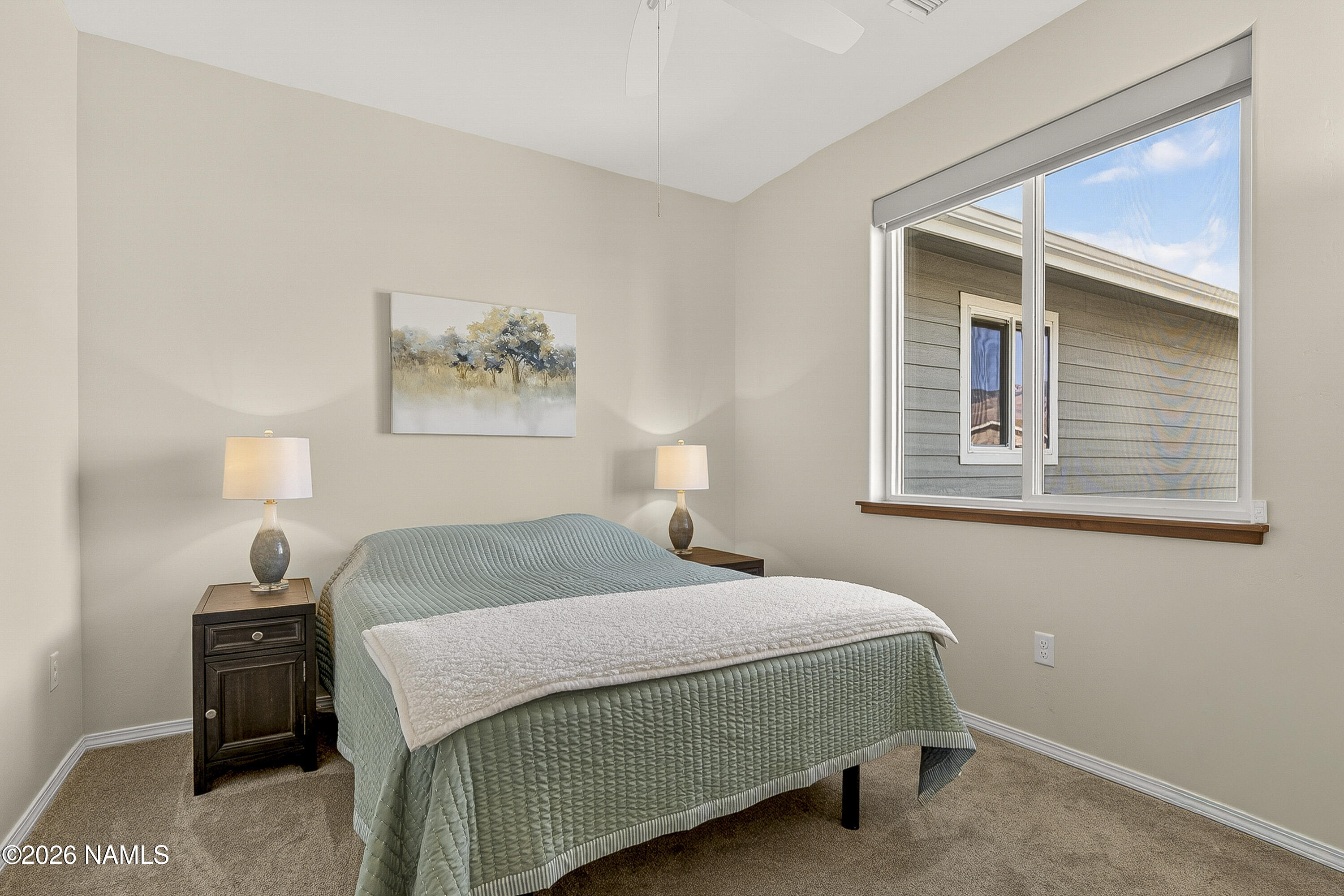 6560 Johnson Ranch Road Flagstaff, AZ 86004 - Photo 24 of 57 a bedroom with a bed and a painting on the wall
