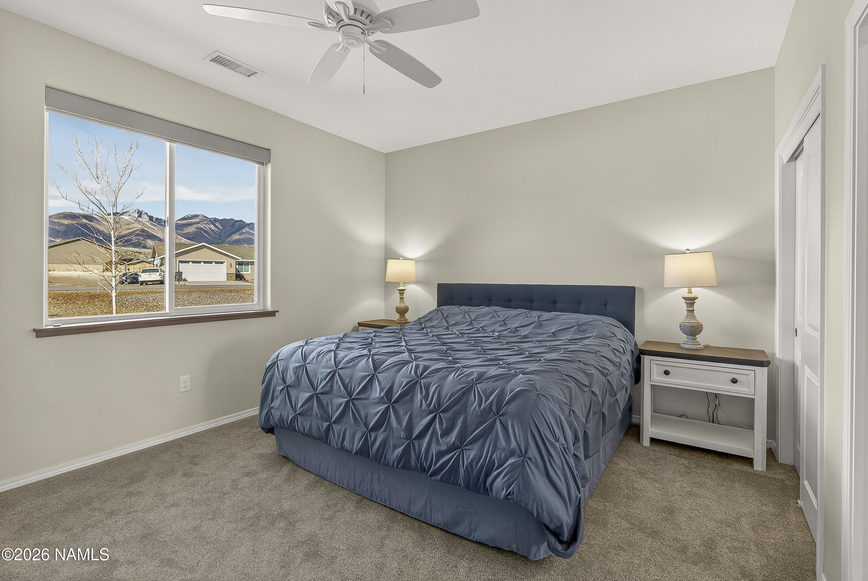 6560 Johnson Ranch Road Flagstaff, AZ 86004 - Photo 25 of 57 a bedroom with a bed and painting on the wall