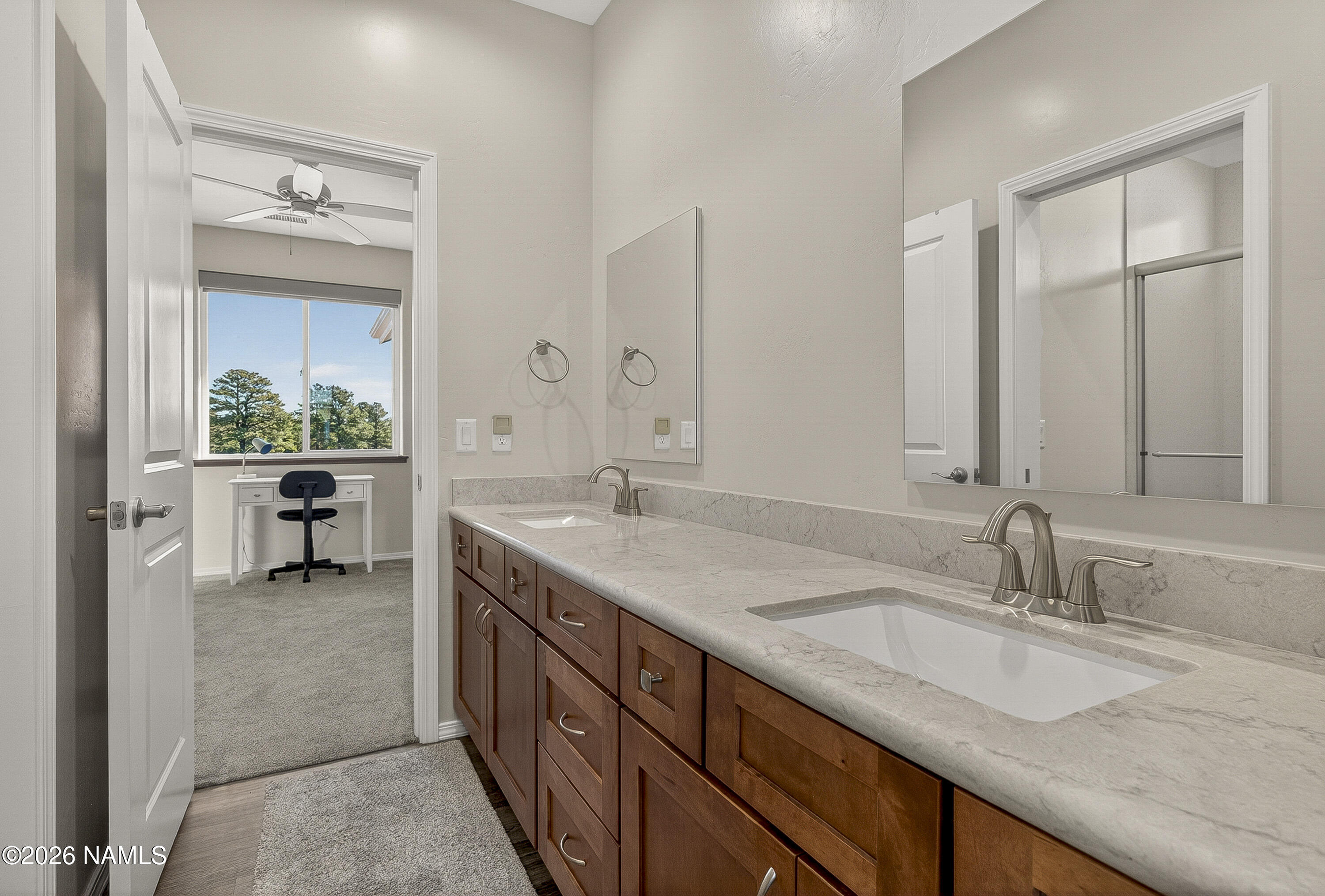 6560 Johnson Ranch Road Flagstaff, AZ 86004 - Photo 29 of 57 a bathroom with a granite countertop sink and a mirror