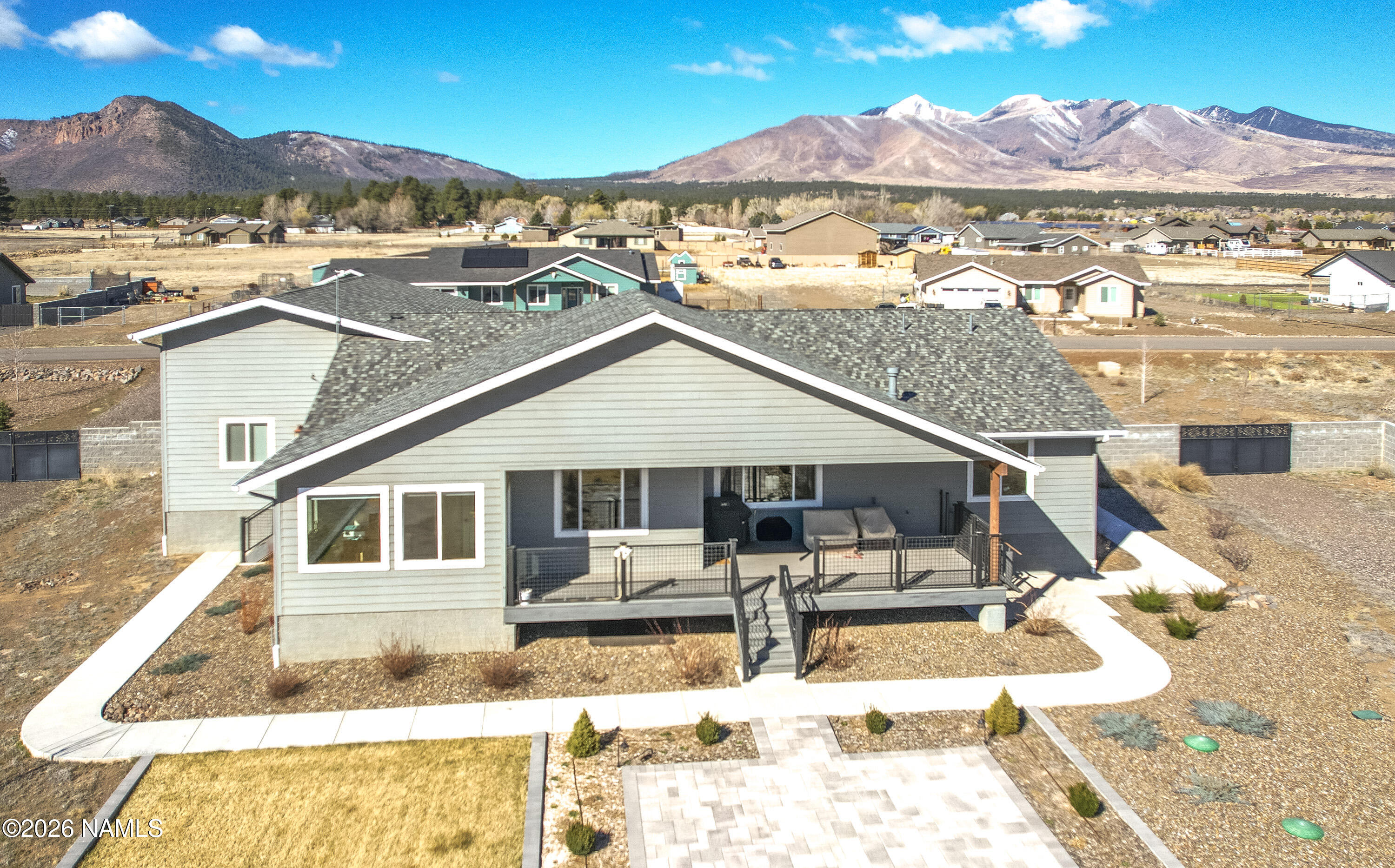 6560 Johnson Ranch Road Flagstaff, AZ 86004 - Photo 3 of 57 a view of a white house with a yard