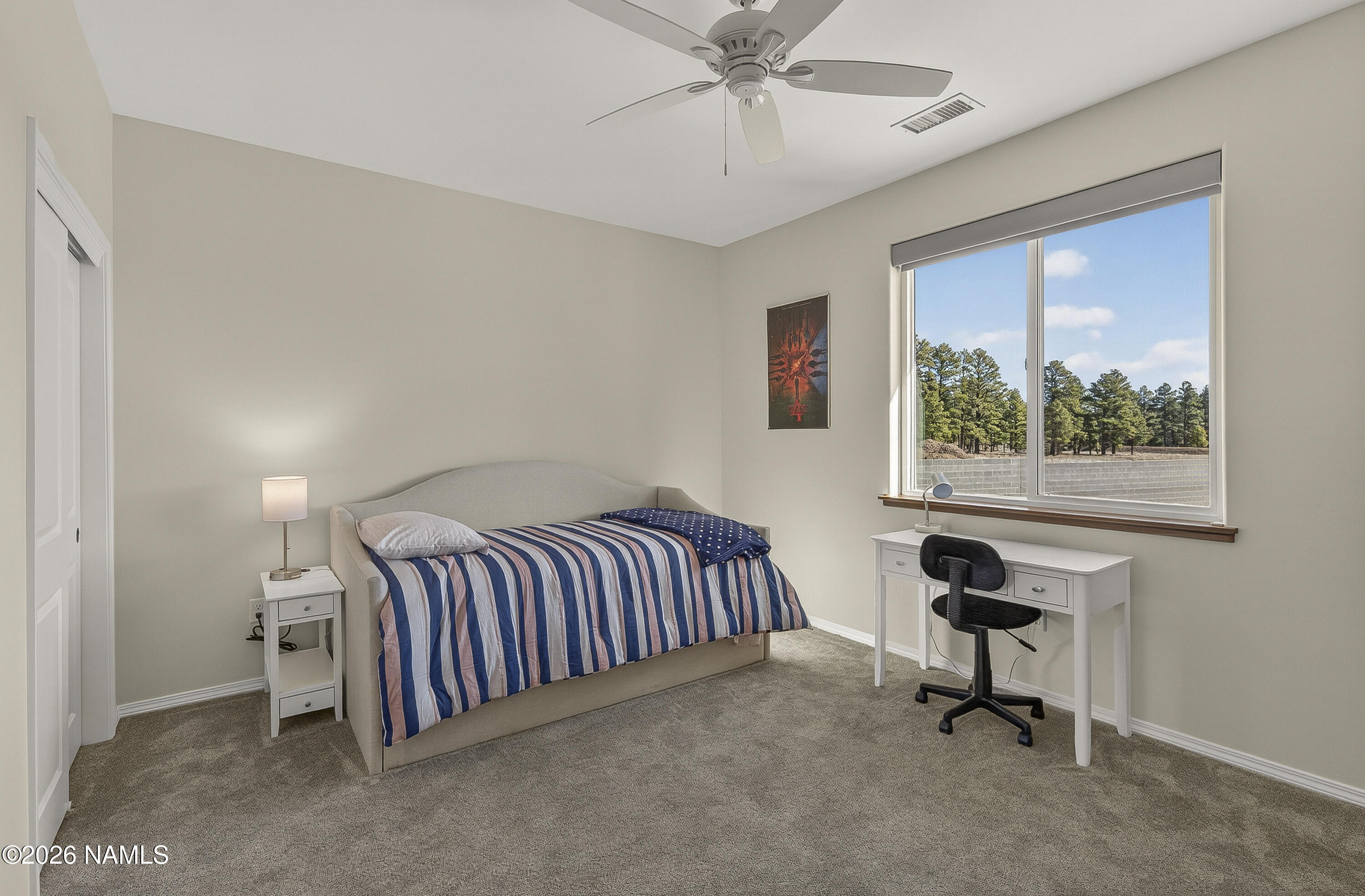 6560 Johnson Ranch Road Flagstaff, AZ 86004 - Photo 31 of 57 a bedroom with a bed and a window