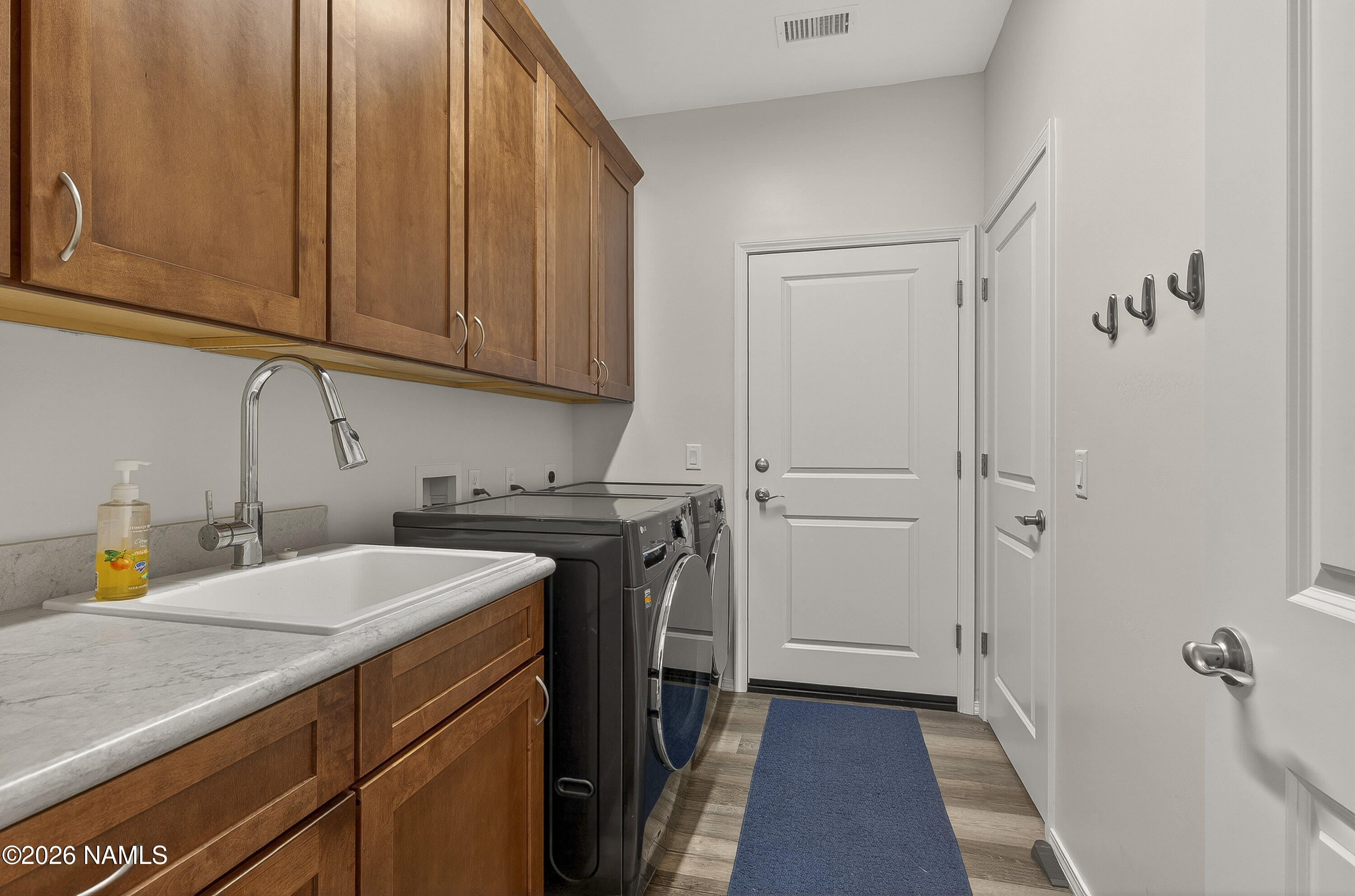 6560 Johnson Ranch Road Flagstaff, AZ 86004 - Photo 34 of 57 a utility room with cabinets washer and dryer
