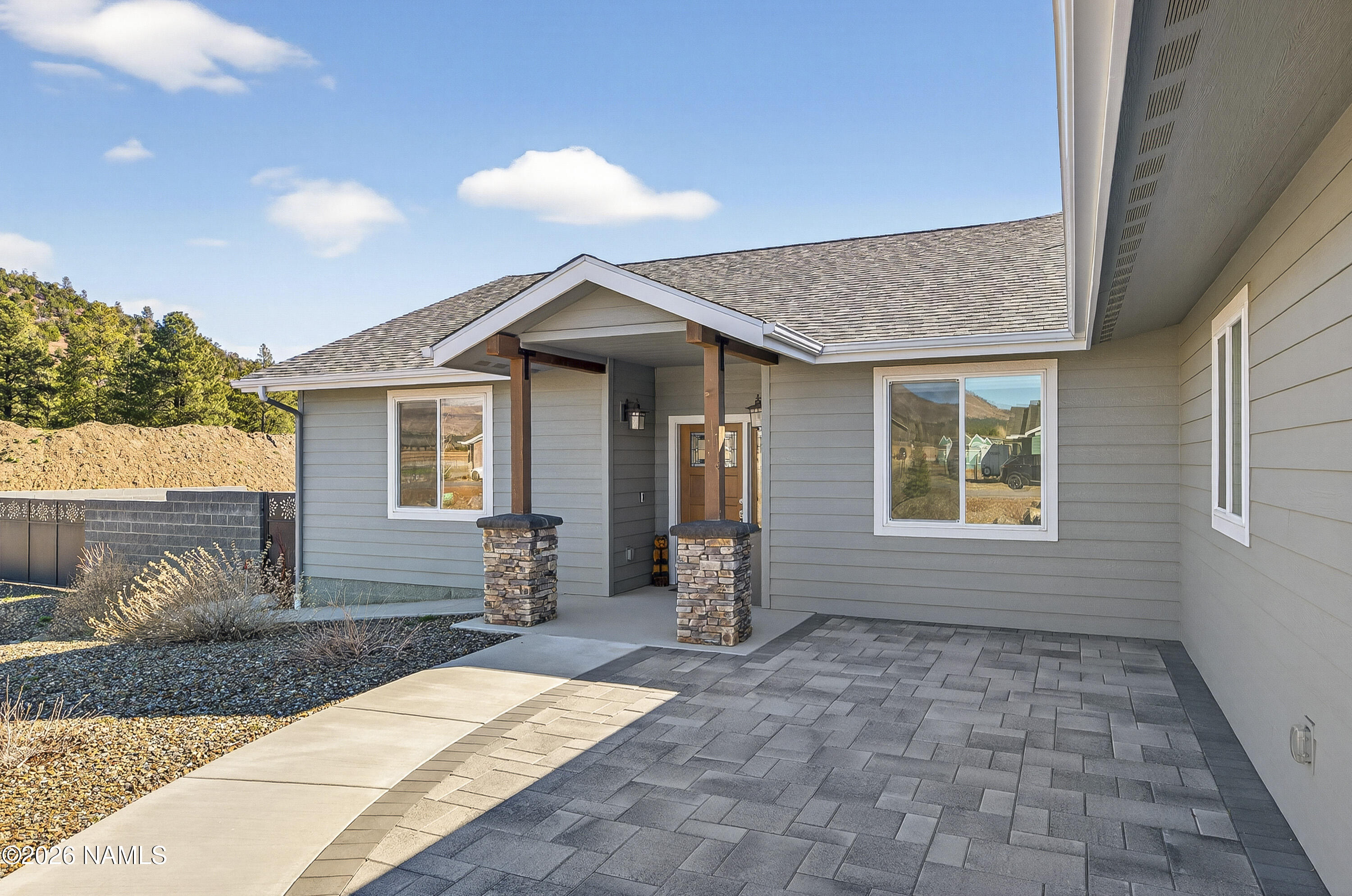 6560 Johnson Ranch Road Flagstaff, AZ 86004 - Photo 4 of 57 a front view of a house with garden