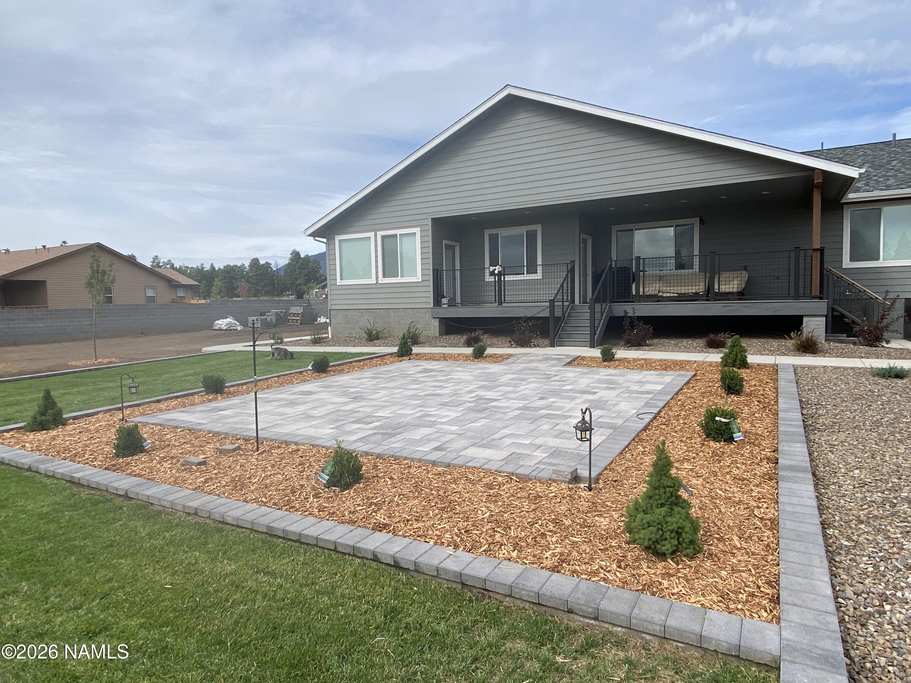 6560 Johnson Ranch Road Flagstaff, AZ 86004 - Photo 55 of 57 a view of a house with backyard and sitting area