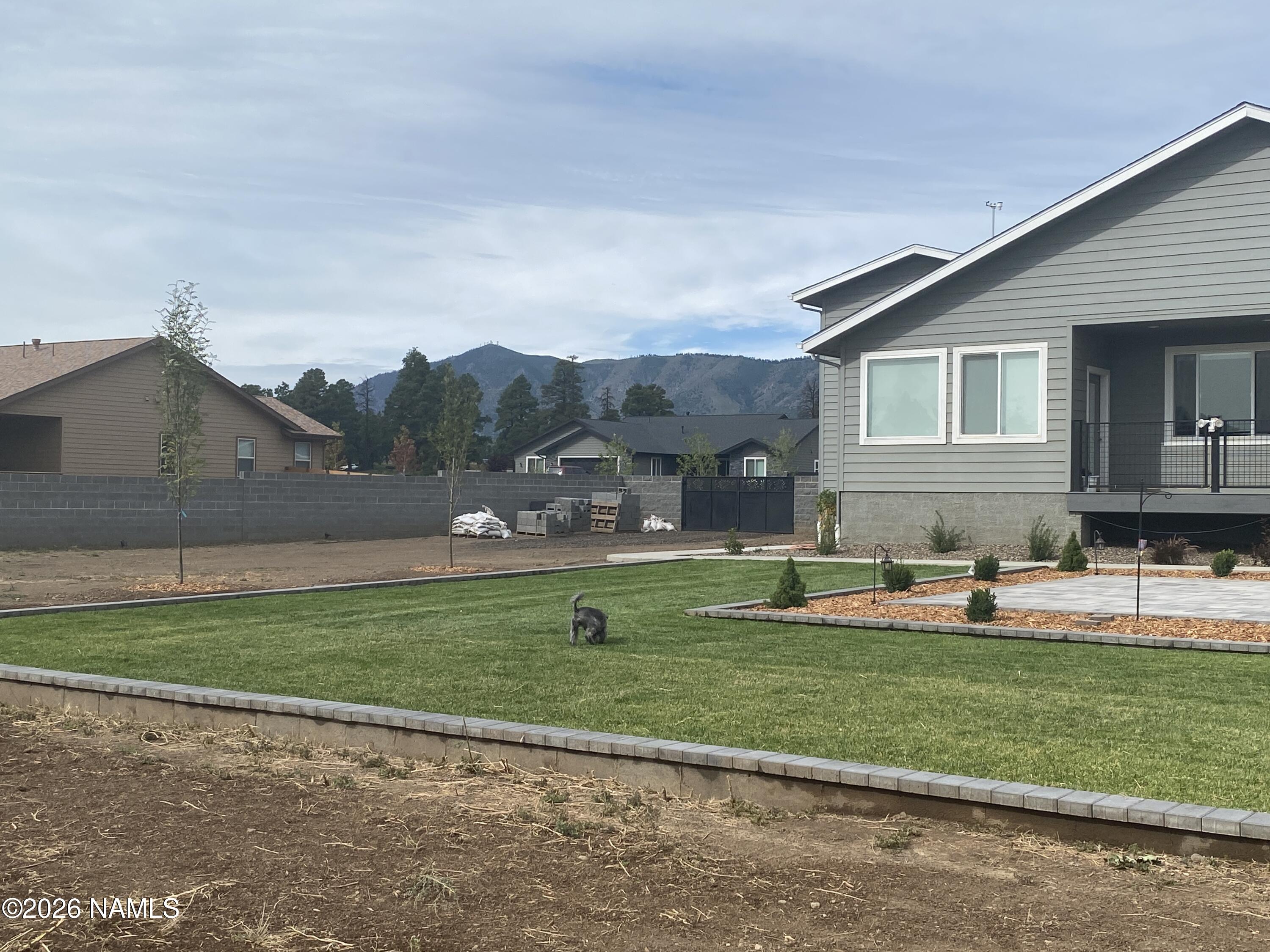 6560 Johnson Ranch Road Flagstaff, AZ 86004 - Photo 56 of 57 a front view of a house with a yard and trees