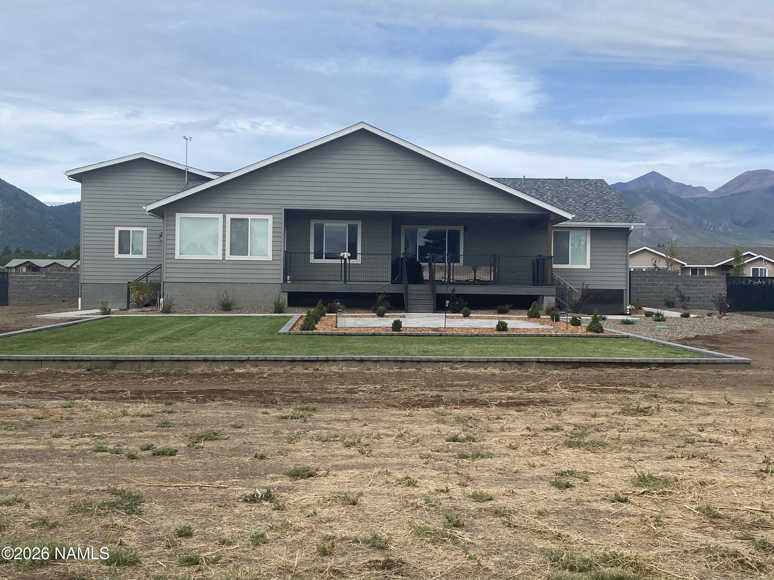 6560 Johnson Ranch Road Flagstaff, AZ 86004 - Photo 57 of 57 a front view of a house with a yard and trees