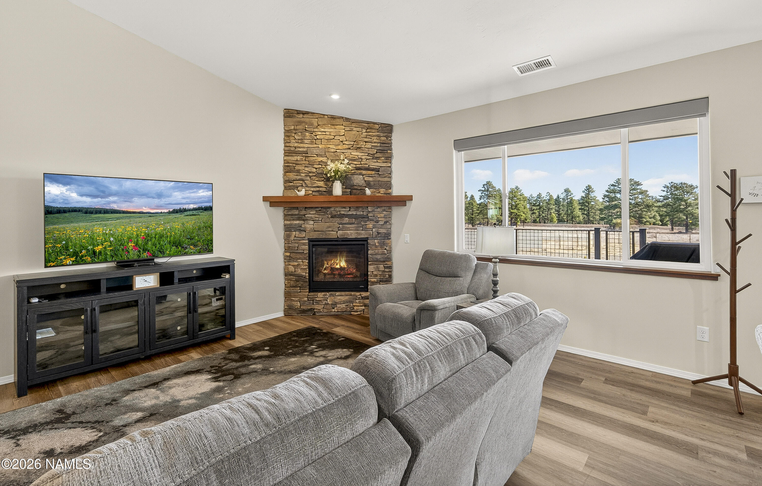 6560 Johnson Ranch Road Flagstaff, AZ 86004 - Photo 8 of 57 a living room with furniture and a fireplace