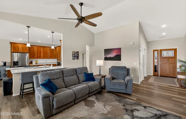 a living room with furniture and kitchen view