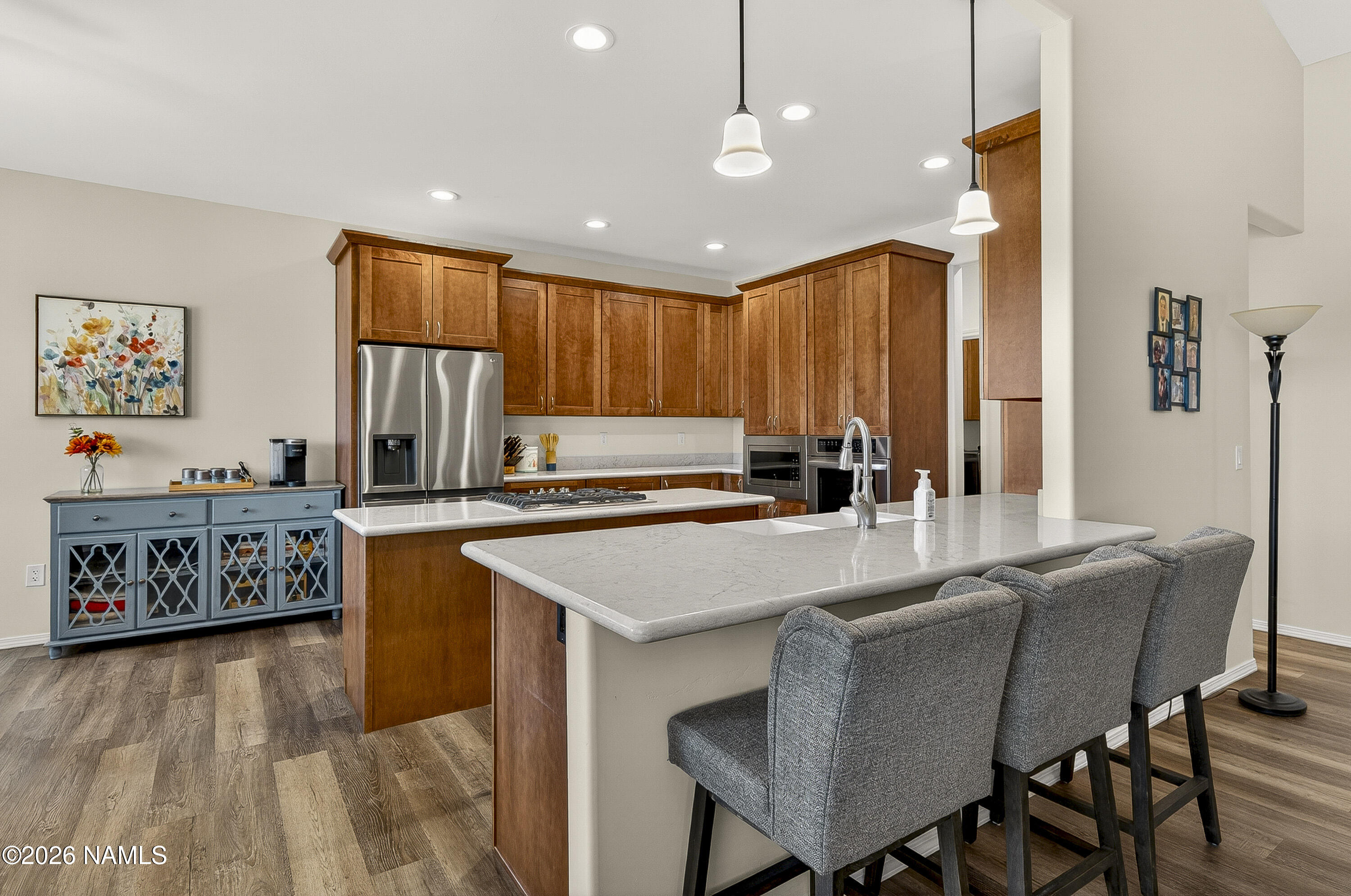 6560 Johnson Ranch Road Flagstaff, AZ 86004 - Photo 10 of 57 a kitchen with stainless steel appliances granite countertop a table chairs sink and window