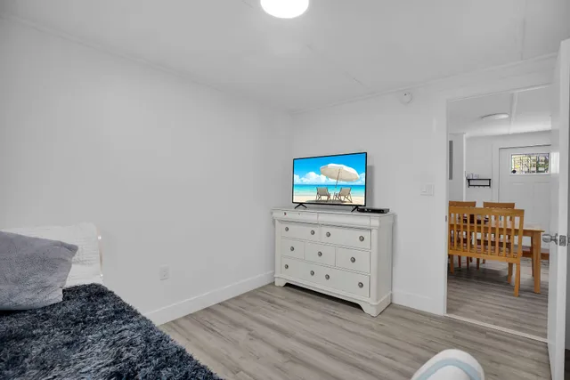 a bedroom with a bed and a night stand