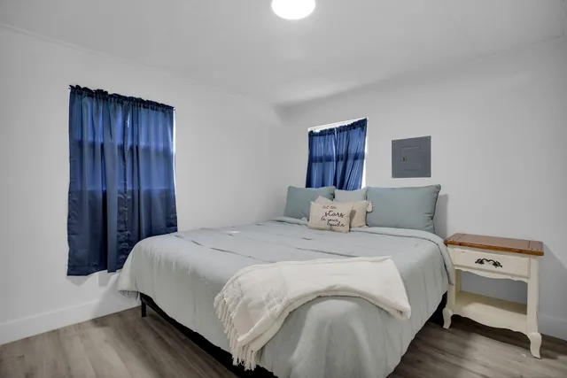 a bedroom with a bed and a painting on the wall