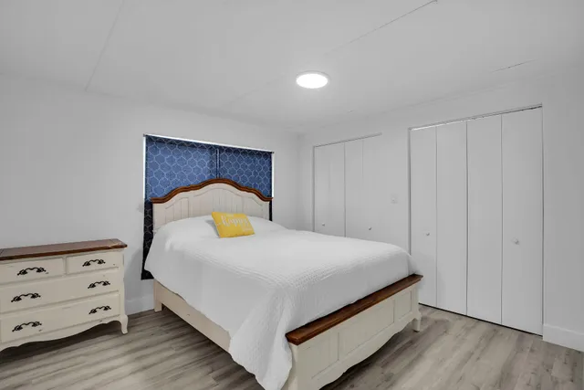 a bedroom with a bed and a lamp on the table