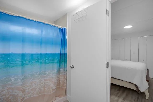 a bathroom with a toilet and a shower