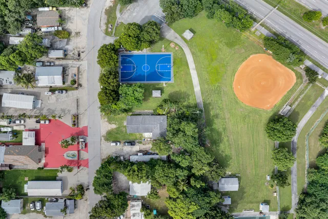an aerial view of a house with swimming pool and garden