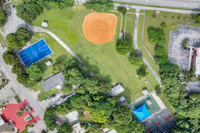 an aerial view of residential houses with outdoor space and lake view