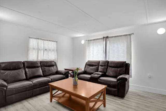a living room with furniture and a kitchen