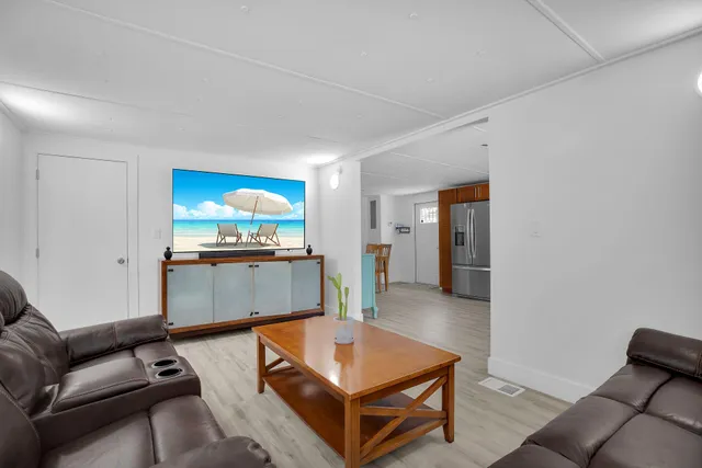 a living room with a bed furniture and a window