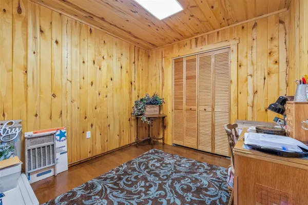 a view of a bedroom with furniture and front door