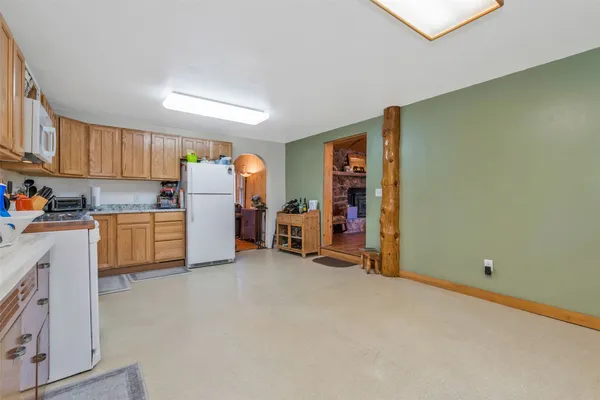 a view of a kitchen with refrigerator and a kitchen