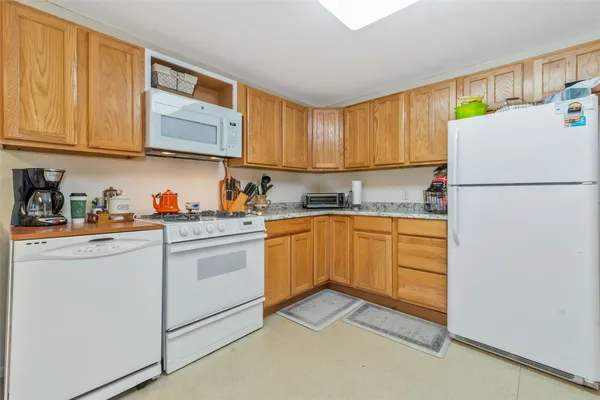 a kitchen with a refrigerator sink and cabinets