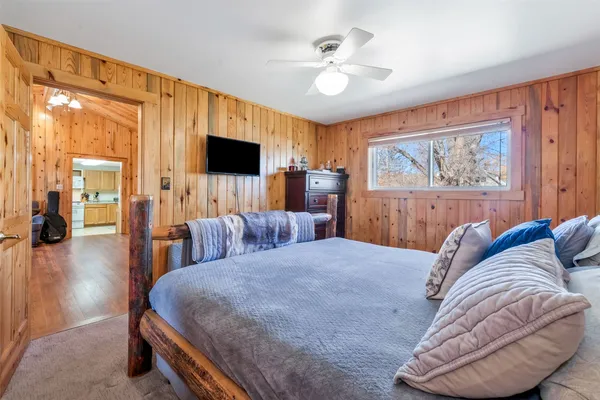 a bedroom with a bed and a chandelier