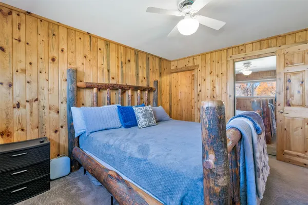 a bed room with a bed and a painting on the wall