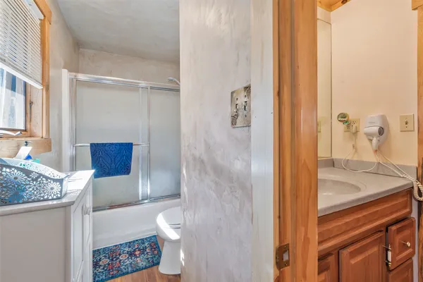 a bathroom with a toilet and a shower